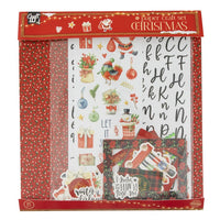 Božićni set za scrapbooking u crvenim tonovima sa ukrasnim papirima i naljepnicama za kreativne projekte.