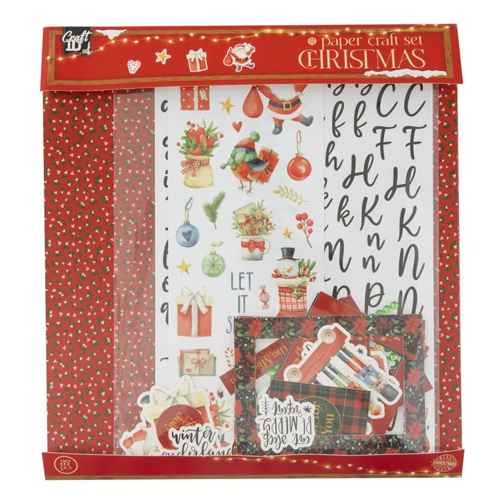 Božićni set za scrapbooking u crvenim tonovima sa ukrasnim papirima i naljepnicama za kreativne projekte.