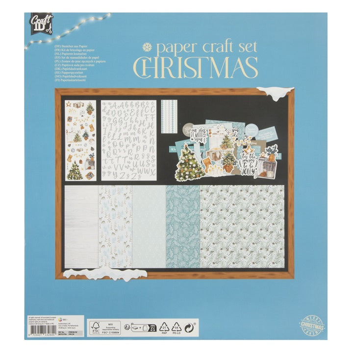 Detaljan prikaz sadržaja plavog božićnog seta za scrapbooking, uključujući ukrase i materijale za izradu čestitki.